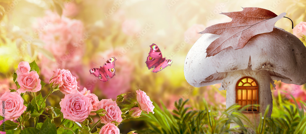 Magical fantasy elf or gnome mushroom house with window and flying butterflies in enchanted fairy tale garden, fabulous fairytale blooming pink rose flower field, shiny glowing sun light in morning - obrazy, fototapety, plakaty 