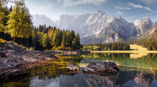 Awesome Alpine Highlands In Sunny Day. Scenic Image Of Fairy-tale Lake During Sunset.  Majestic Rocky Mountains On Background. Wild Area. Fusine Lake. Italy, Julian Alps. Best Travel Locations.
