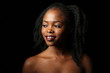 © daryakomarova - Portrait of a young beautiful African woman with thick black curly hair on an isolated black background. The woman smiles