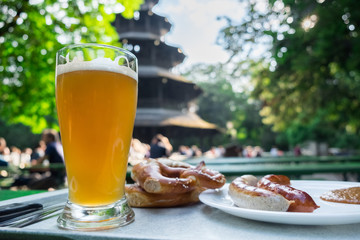 National bavarian cuisine. White beer, white sausage and pretzel with salt. Outdoor in a beer garden in Muhich.