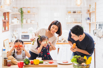 Wall Mural - Asian family enjoy playing and cooking food in kitchen at home