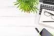 © galinat35 - Business concept - Top view of white desktop background with notebook, smart phone, plant and clip for mockup design