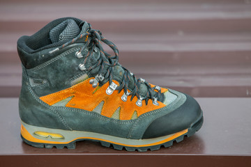 A leather trekking hiking winter boot on blurred background