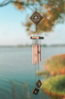 a wind chime meaning water element. summer lake on blurry background