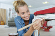 © auremar - woman painting renewing chair at home
