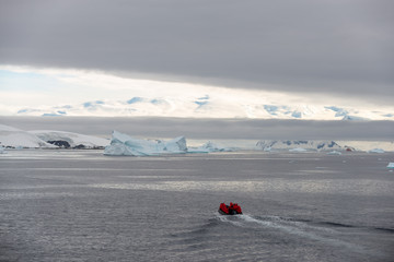 Inflatable boat with tourists at sea in Antarctica