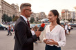 © Svitlana - Its time to get connected. Professional reporter interviewing woman on urban street. Journalism industry, live streaming concept