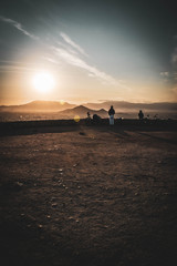 Wall Mural - silhouette of man on city at sunset