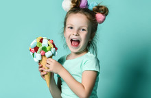 Closeup Portrait Of Happy Little Girl Kid Holding Big Ice Cream In Waffles Cone With Tasty Toppings Berry Marshmallow