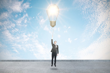 Poster - Businessman holding light bulb