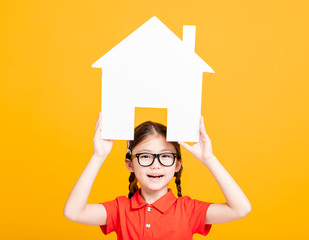 Wall Mural - happy little girl showing and  holding house model