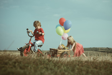 Wall Mural - Funny little girl and boy. Copy space. Happy kids smiling and having fun. Little kid outdoor. Emotional child. Happy moments. Charming boy and girl. Posing outside. Happy brother and sister.