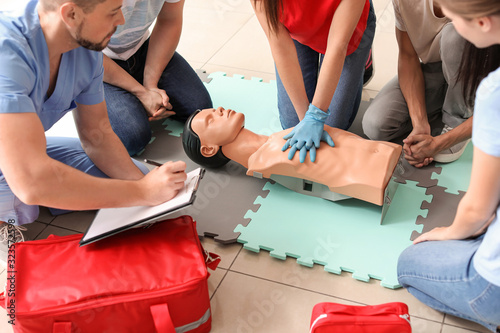 Cuadros en Lienzo Instructor demonstrating CPR on mannequin at first aid training course