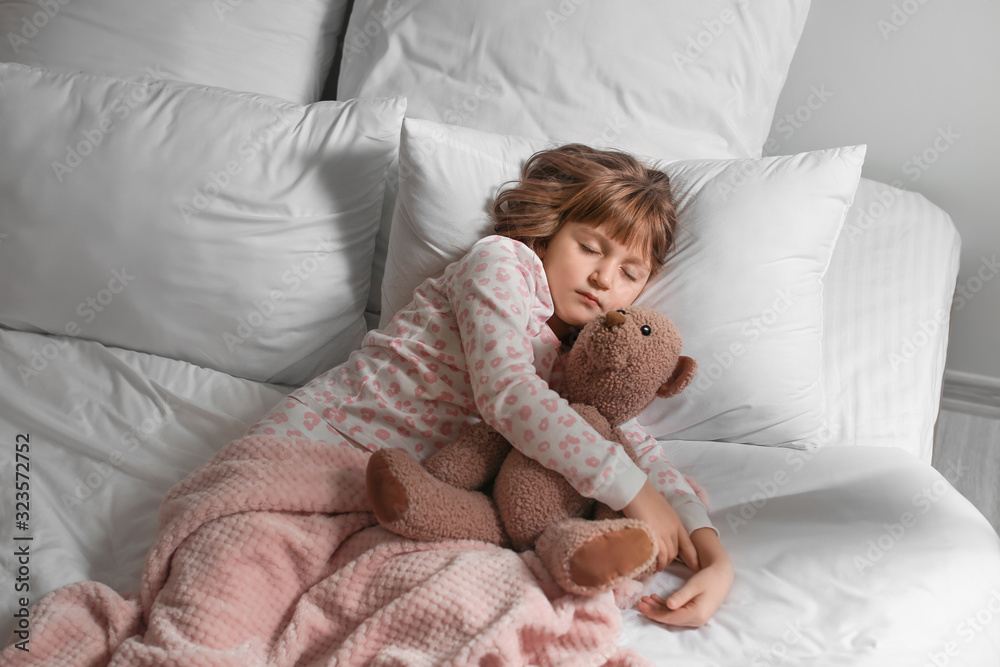 Cute little girl sleeping in bed