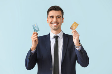 Sticker - Male bank manager with credit cards on light background