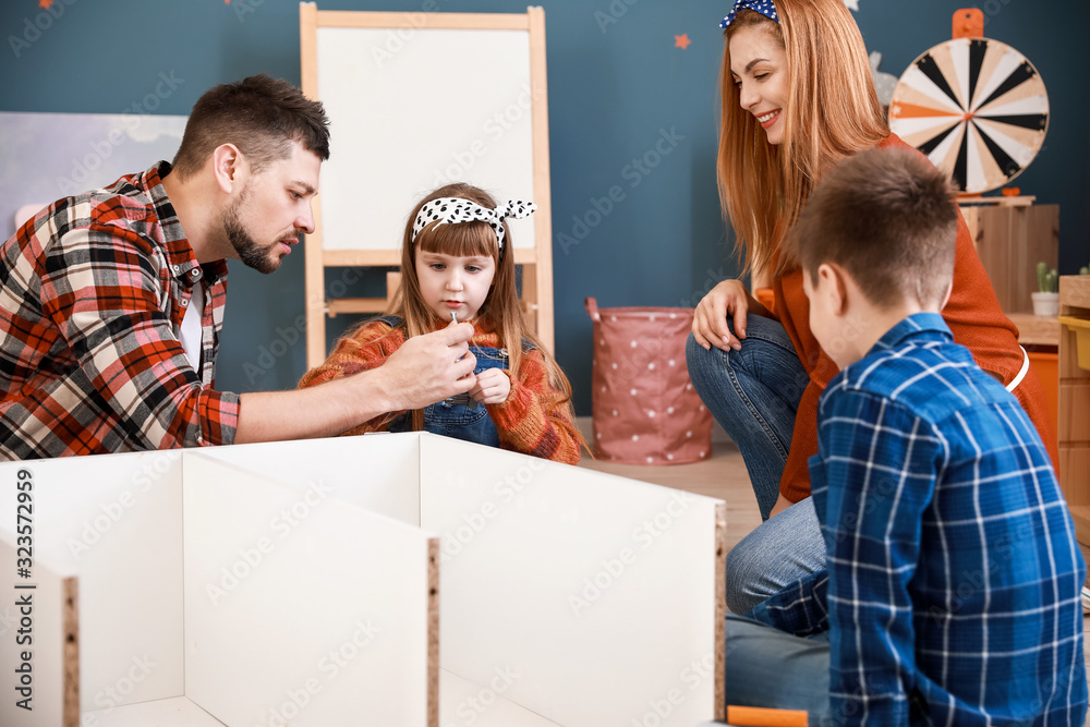 Family assembling furniture at home