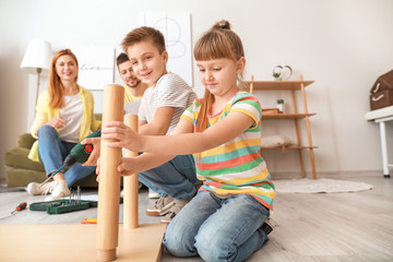 Sticker - Family assembling furniture at home