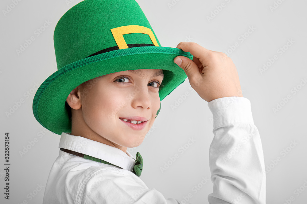 Funny little boy on white background. St. Patrick's Day celebration