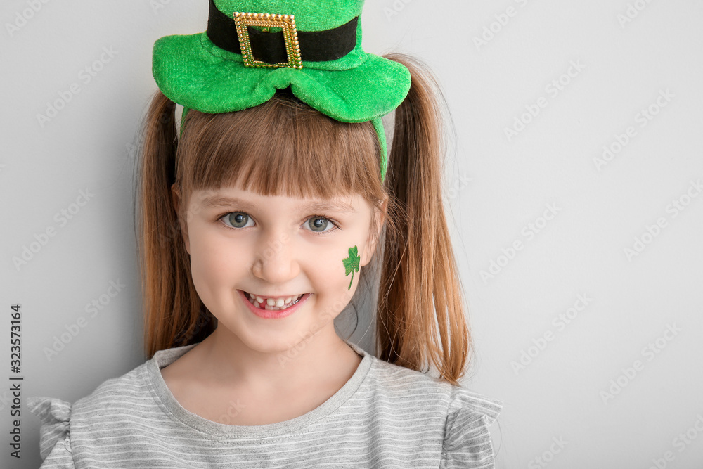 Funny little girl on white background. St. Patrick's Day celebration