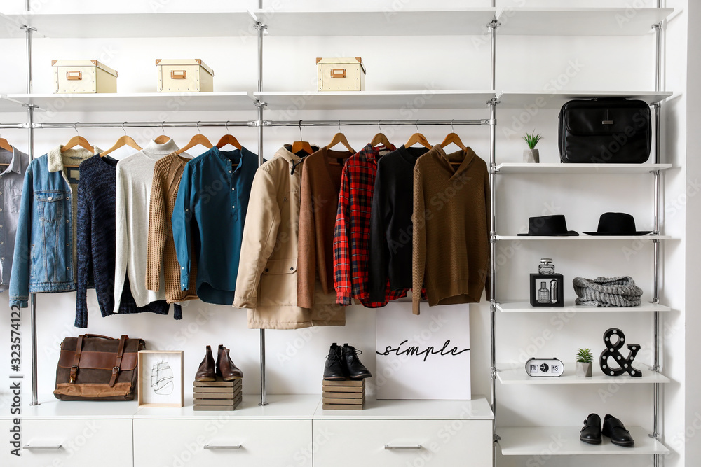 Modern wardrobe with stylish winter clothes and accessories