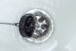 Sharply open drain plug for the bathroom. The whirlpool of water.