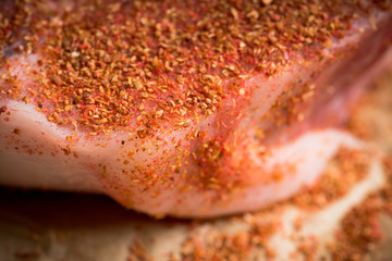 Wall Mural - Raw fresh meat with spices on the rustic background. Selective focus. Shallow depth of field.