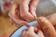 © marketlan - A grandma and a girl manually makes homemade sausage using natural gut. Tie a thread on the sausage.Traditional cuisine. Selective focus