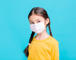 © Tom Wang - sick Girl child in medical mask isolated on blue background