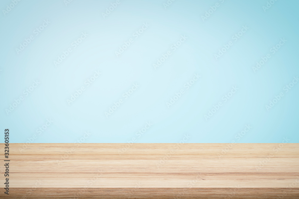 Empty Blue Back Table Empty wooden deck table over light blue wallpaper background for ...