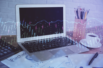 Stock market graph and table with computer background. Double exposure. Concept of financial analysis.