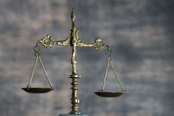 Law and Justice concept. Mallet of the judge, books, scales of justice. Gray stone background, reflections on the floor, place for typography. Courtroom theme.. Wooden rustic background