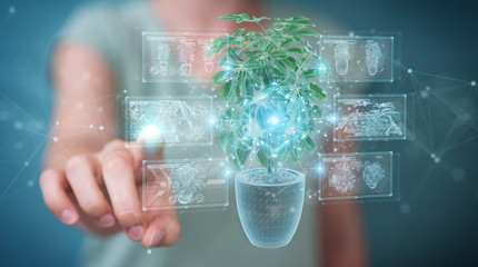 Fototapete - Woman holding and touching holographic projection of a plant with digital analysis 3D rendering