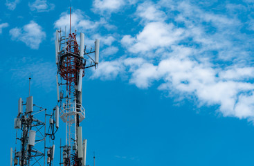 Telecommunication tower with blue sky and white clouds background. Antenna on blue sky. Radio and satellite pole. Communication technology. Telecommunication industry. Mobile or telecom 4g network.