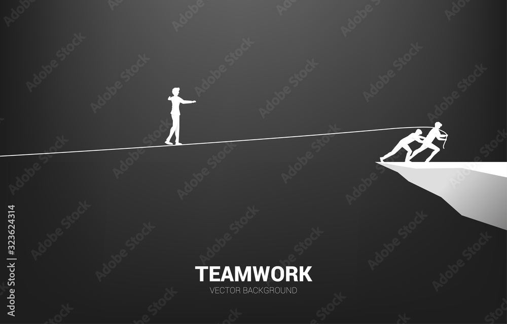 Silhouette of businessman walking on rope walk way pulled by team.Concept for teamwork and team support.. - obrazy, fototapety, plakaty 