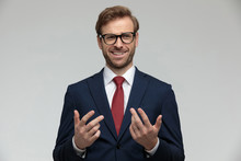 Businessman Standing With Hands Raised And Looking Away Happily Disgusted