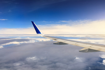 Airplane flying at high altitude and beautiful high-altitude clouds in spring