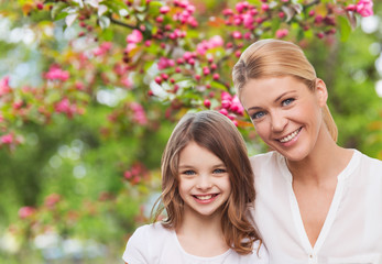 Poster - family, motherhood and people concept - happy smiling mother and daughter over cherry blossom background