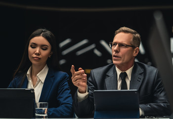 Wall Mural - The man and woman sitting at the table on business meeting