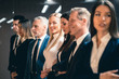© Artem - The team of businesspeople standing indoor