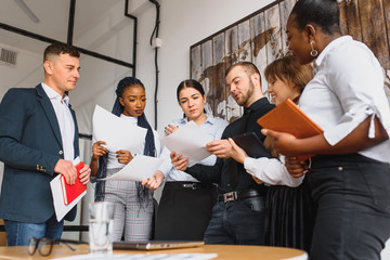 Group portrait of multiethnic business people smiling in office