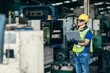 © Quality Stock Arts - Asian engineer programming the machine in factory with laptop computer to setup program process.