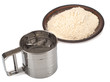 Metal flour sifter and flour in plate Isolated on a white background