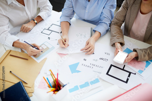 Fotografía High angle shot of three unrecognizable designers collaborating on project