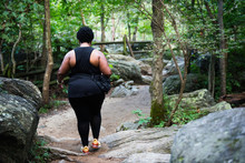 Woman Walking Up Mountain Nature Trail