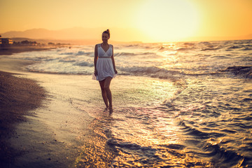 Wall Mural - Carefree Woman Enjoying Beautiful Sunset