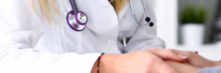 Wall Mural - Friendly female doctor hold patient hand in office