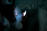 Fototapeta Zwierzęta - Asian woman playing game on smartphone in the bed at night,Thailand people,Addict social media