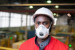 © pressmaster - Horizontal head and shoulders portrait of unrecognizable Black male factory engineer wearing protective mask looking at camera