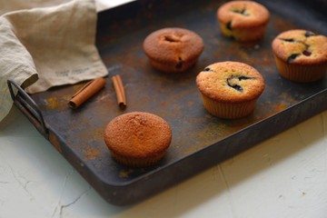 Wall Mural - Baked muffins with cinnamon and chocolate on a griddle plate