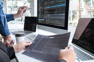 team of developer programmer working on project in software development computer in it company offic